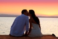 Couple in love, kissing at sunset, to represent reconnecting with lost love with the aid of Psychic Elaine Palmer