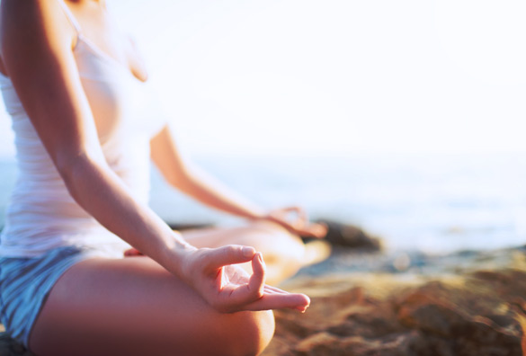 woman-doing-breath-exercises-in-a-yoga-pose-on-the-beach
